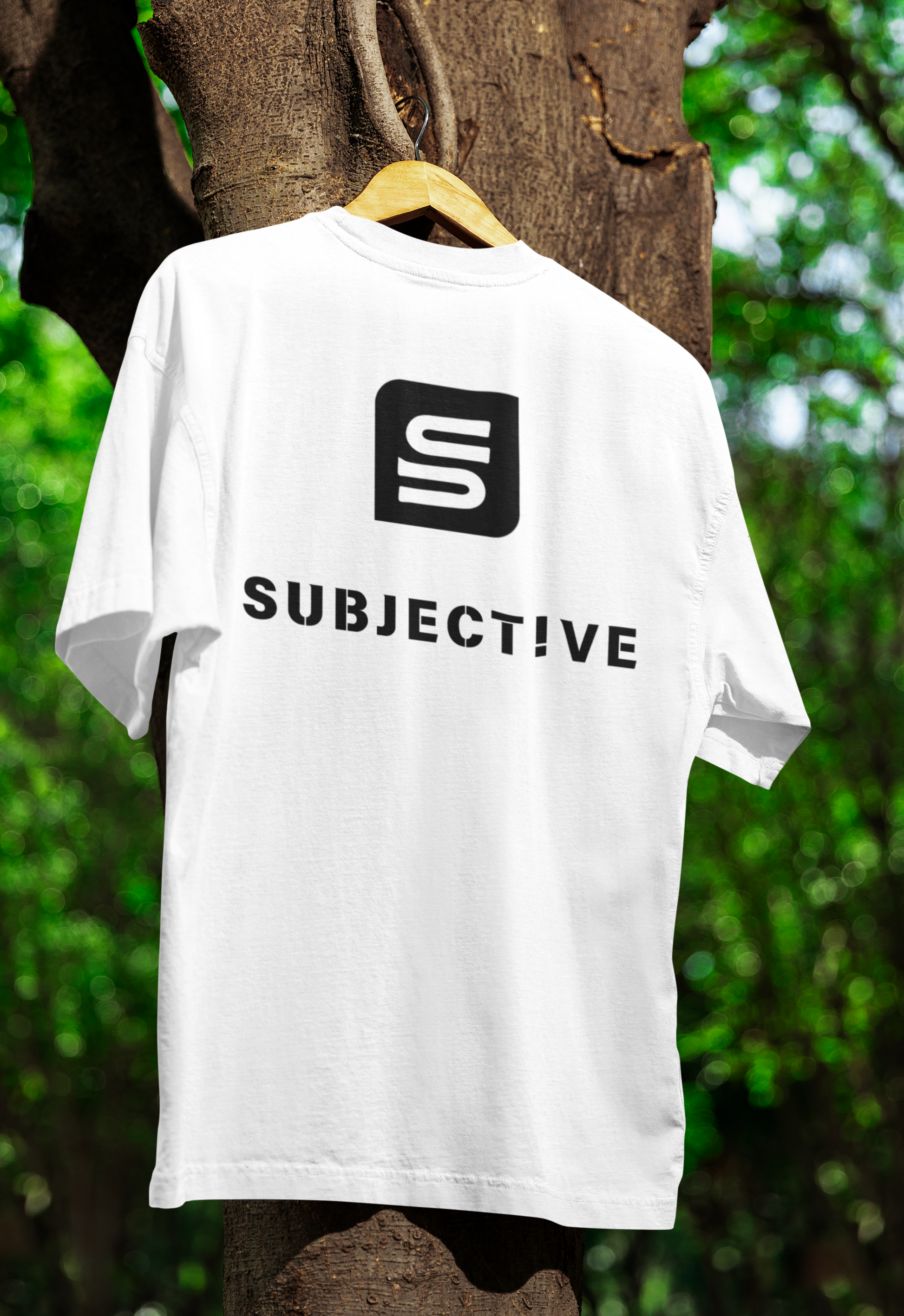 oversized- Subjective-tee-hanging-from-a-tree. Front View. Living Subjective